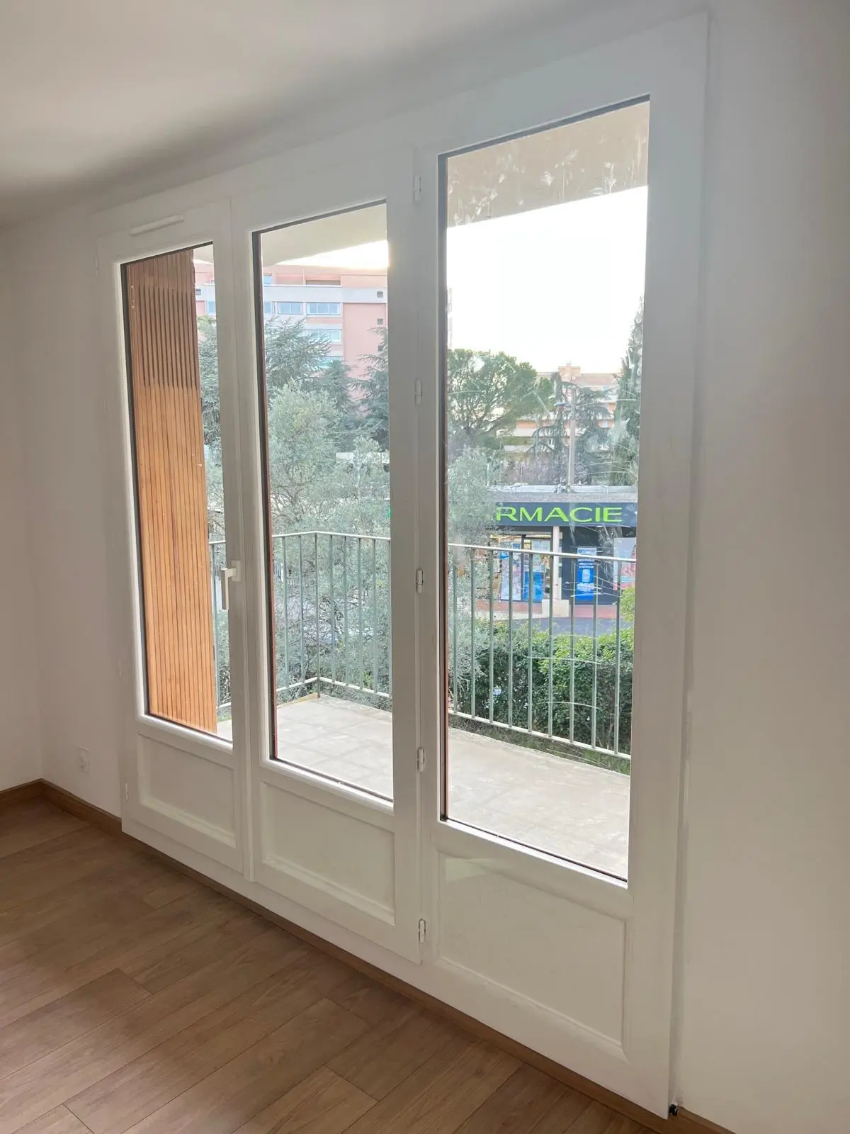 Porte-fenêtre PVC blanche donnant sur un jardin